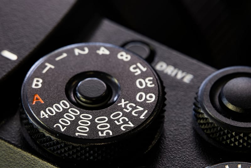 Close-up of a camera shutter speed dial used to illustrate exposure control in crime scene photography training