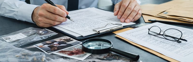 Consultant sitting at a desk reviewing reports