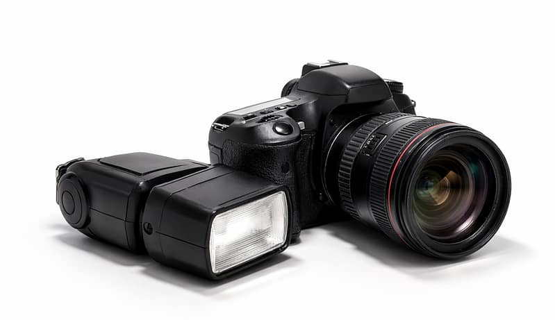 Image of a camera and a detached camera flash adjacent to it.